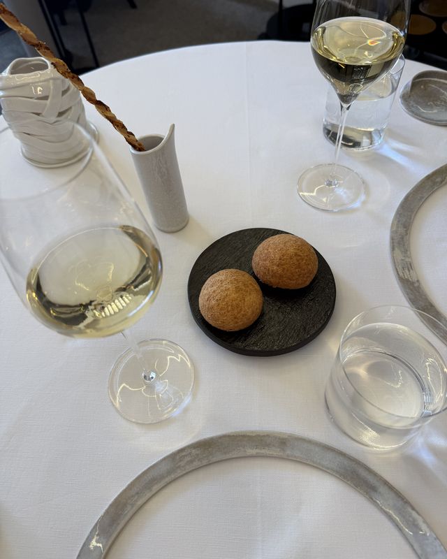 Overhead flatlay of bread service on dark stone