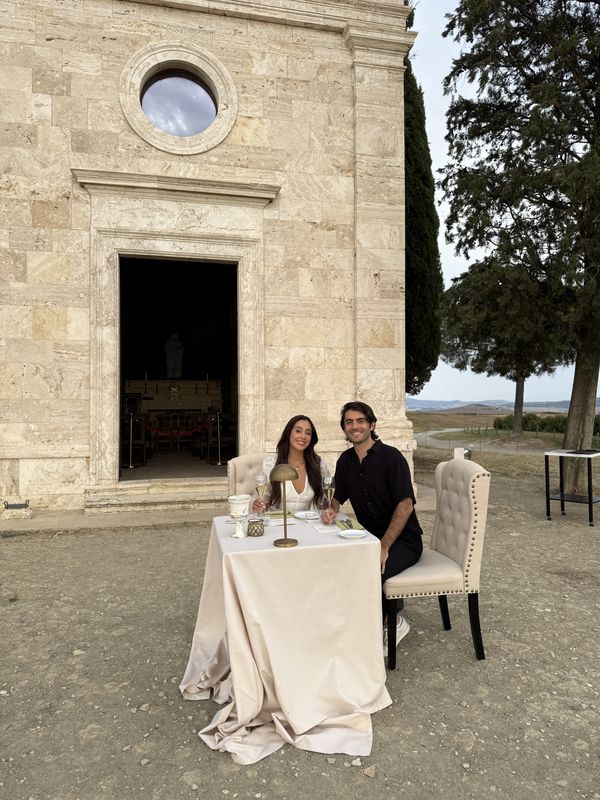 A table for two outside a chapel in Val d'Orcia